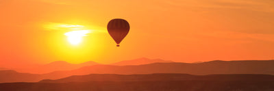 panoramic-canvas-print-hot-air-balloon-at-sunset-panorama